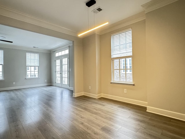 spare room featuring baseboards, ceiling fan, dark wood-style flooring, crown molding, and french doors