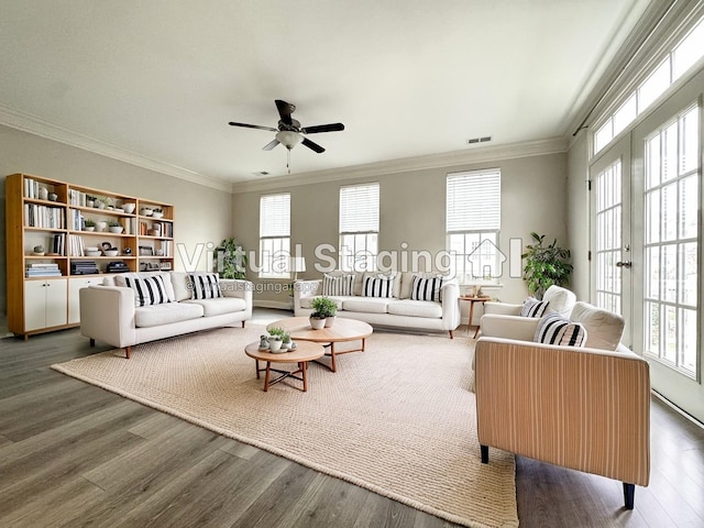 living area with visible vents, ornamental molding, wood finished floors, and french doors