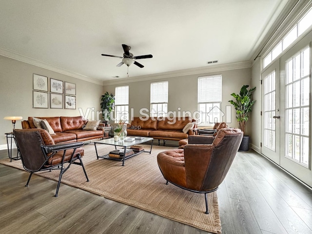 living area featuring ornamental molding, french doors, plenty of natural light, and wood finished floors