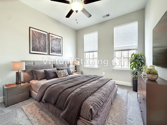 bedroom featuring light carpet, baseboards, visible vents, and ceiling fan