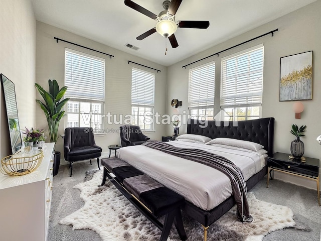 bedroom with carpet floors, visible vents, and a ceiling fan