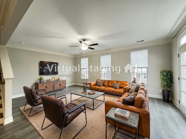 living room with dark wood-style floors, visible vents, and crown molding