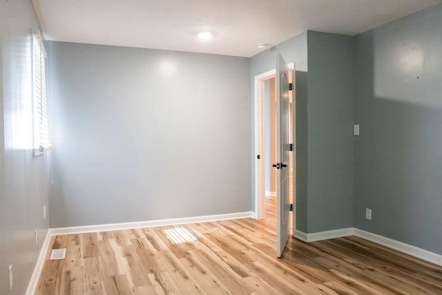 empty room featuring light wood-style flooring and baseboards