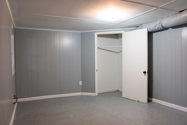 unfurnished bedroom featuring a closet, baseboards, and speckled floor