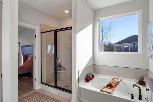 bathroom with a garden tub, connected bathroom, and a shower stall