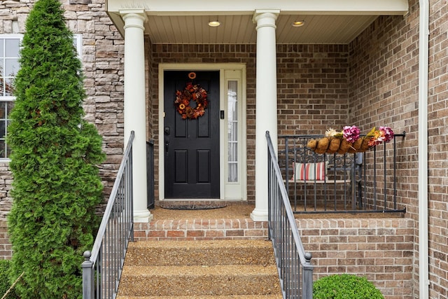 entrance to property with stone siding and brick siding