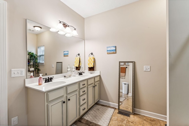 full bath with double vanity, visible vents, baseboards, and a sink