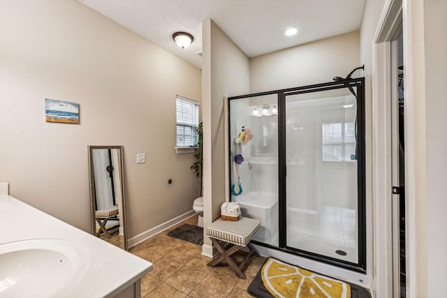 bathroom with toilet, a shower stall, tile patterned flooring, and vanity