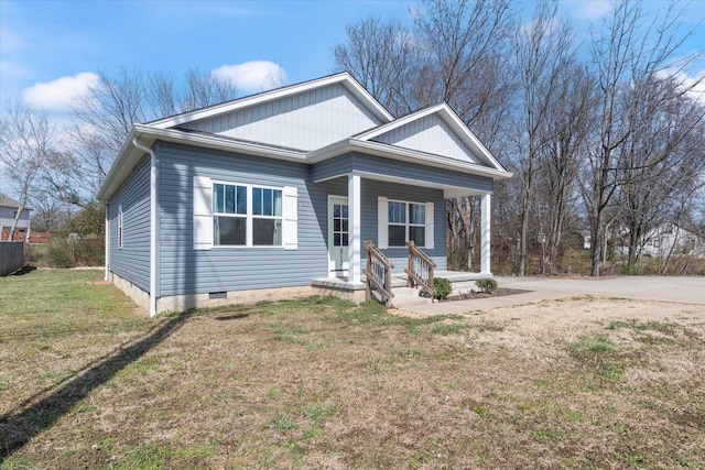 view of front facade featuring covered porch, a front lawn, and crawl space