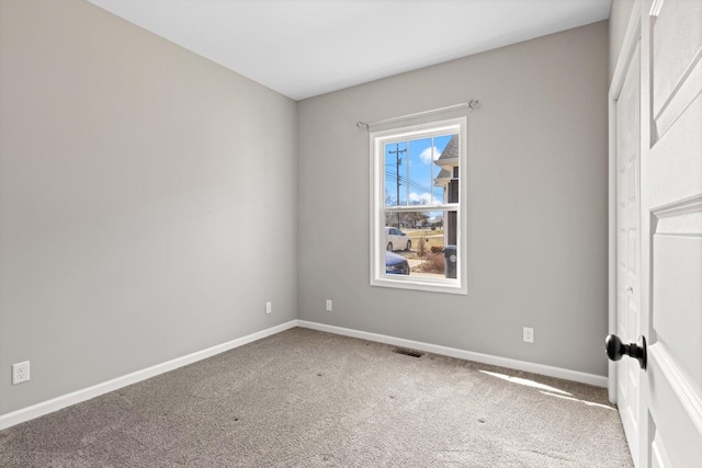 unfurnished bedroom with carpet flooring, visible vents, and baseboards