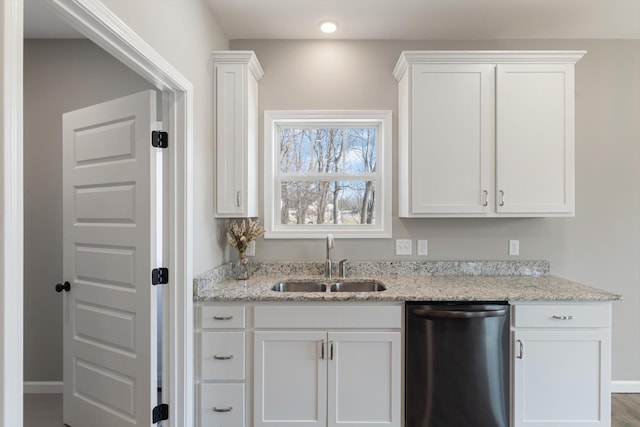 kitchen featuring a sink, light stone countertops, white cabinets, and dishwasher