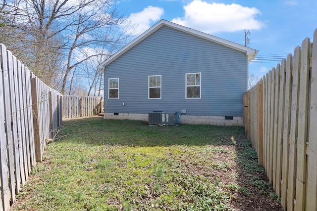 view of side of home with crawl space, a fenced backyard, a yard, and central air condition unit