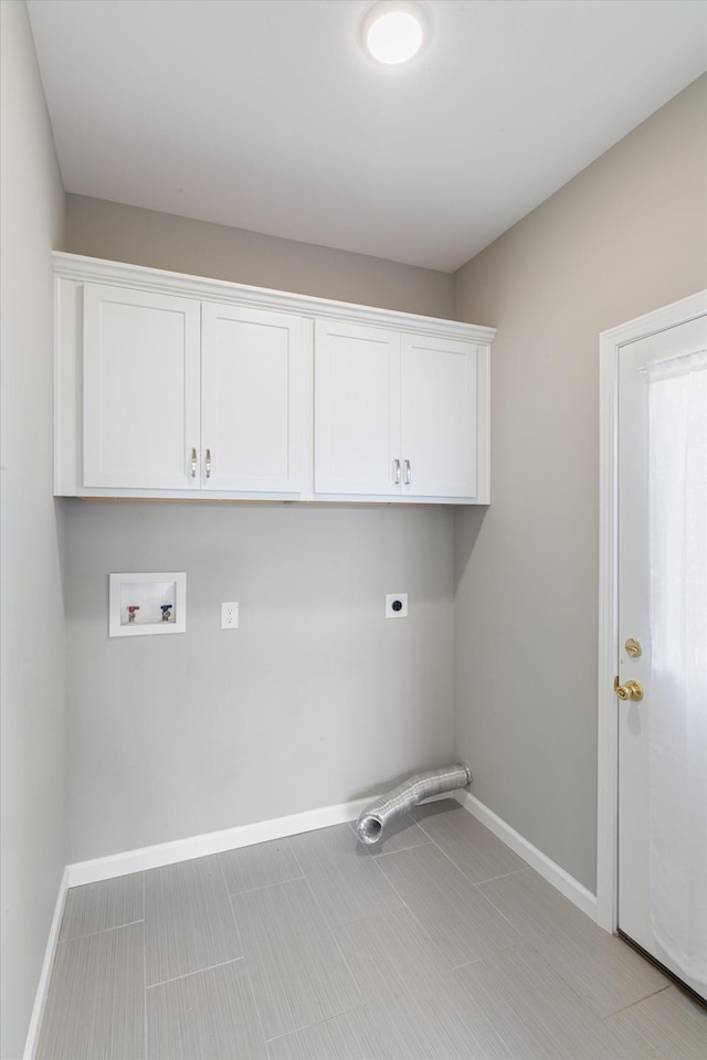 laundry area with hookup for a washing machine, cabinet space, electric dryer hookup, and baseboards