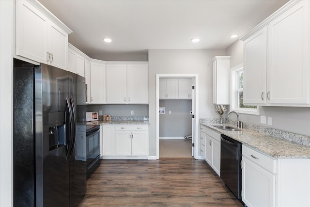 kitchen with dark wood-style floors, black appliances, and white cabinets