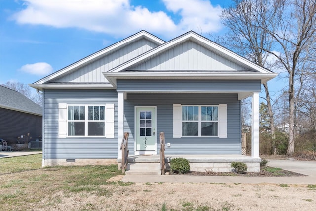 view of front of property with central AC unit, a porch, and a front yard