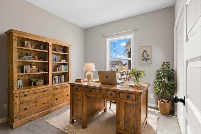 office space featuring carpet floors and baseboards