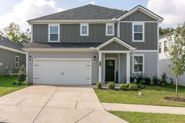 view of front of house featuring a shingled roof, concrete driveway, an attached garage, board and batten siding, and a front yard