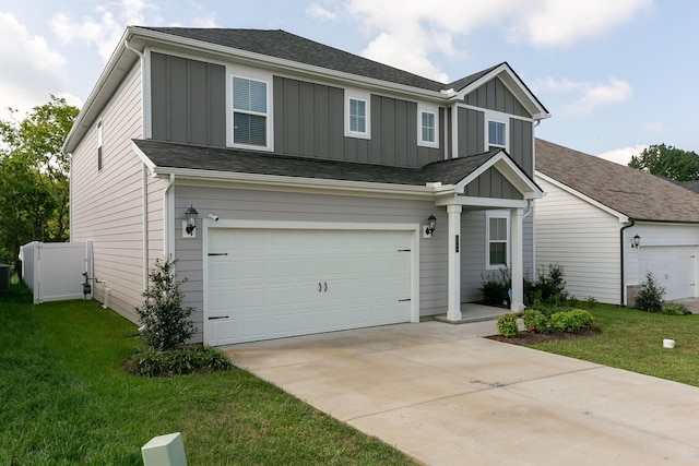 traditional-style home with board and batten siding, a front yard, concrete driveway, and a garage