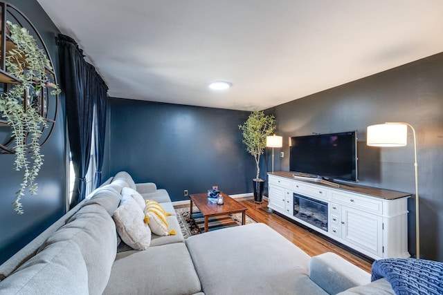 living room featuring baseboards and wood finished floors