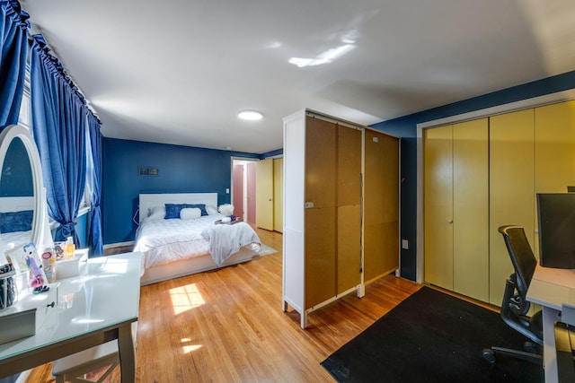 bedroom with light wood-style flooring and a closet