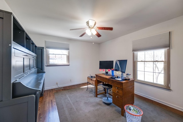 office area with dark wood-style floors, baseboards, and a ceiling fan