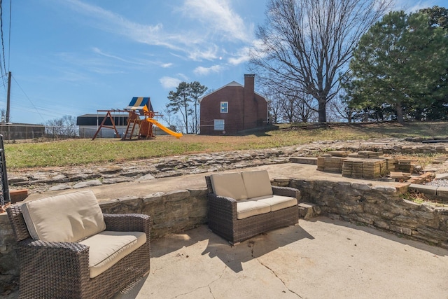 view of patio featuring fence and a playground