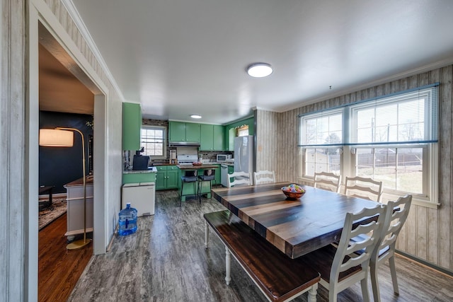 dining space featuring dark wood-style floors and ornamental molding