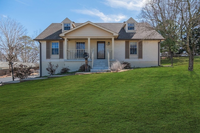 view of front of home with a porch, a front lawn, and brick siding