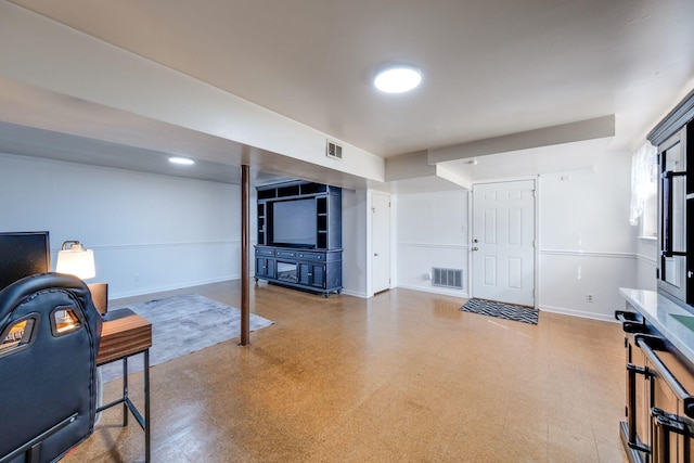 living room with visible vents, baseboards, and tile patterned floors