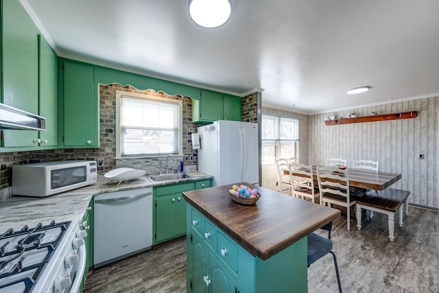 kitchen featuring dark wood-type flooring, white appliances, green cabinetry, and a sink