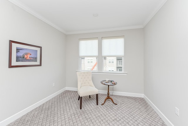 sitting room featuring crown molding, baseboards, and carpet floors