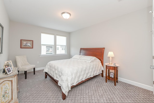 carpeted bedroom with baseboards