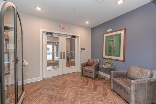 living area featuring recessed lighting, french doors, and baseboards