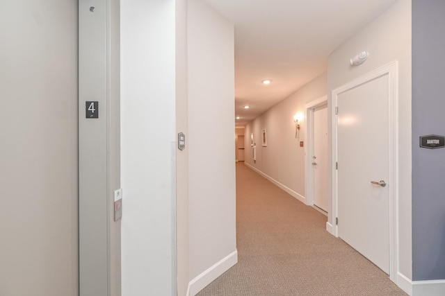 corridor with recessed lighting, baseboards, and light colored carpet