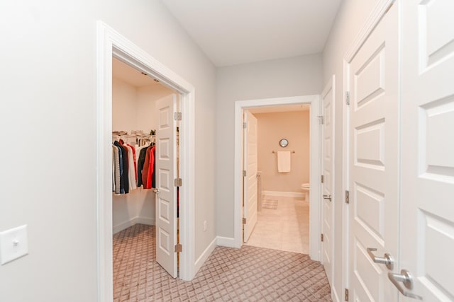 hallway featuring baseboards