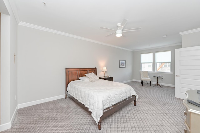 carpeted bedroom featuring crown molding, a ceiling fan, and baseboards