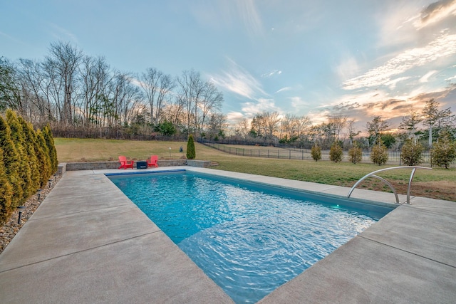 view of swimming pool featuring a lawn, a patio area, fence, and a fenced in pool