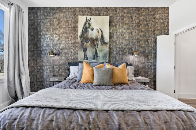 bedroom with baseboards and wood finished floors