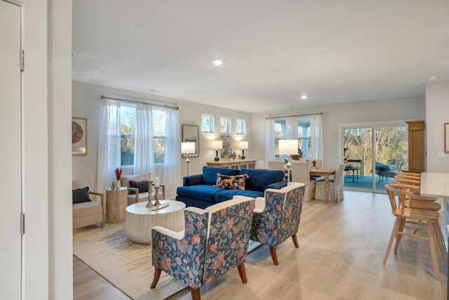 living area featuring light wood finished floors and recessed lighting