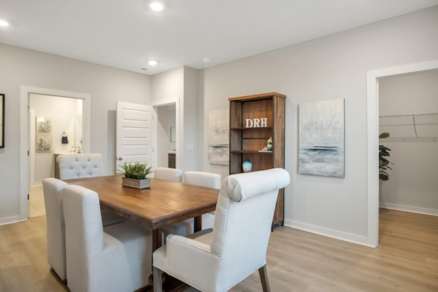 dining room featuring baseboards, recessed lighting, and light wood-style floors