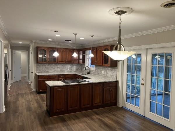 bar featuring dark wood-style floors, a sink, black electric cooktop, and crown molding