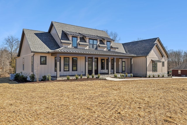 modern farmhouse style home featuring a standing seam roof, metal roof, board and batten siding, and roof with shingles