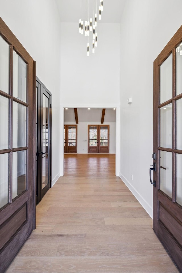 998 Iron Hill Rd, Burns, TN 37029 - entryway featuring light wood-type flooring, french doors, a towering ceiling, and baseboards