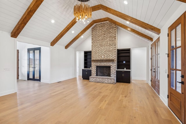 998 Iron Hill Rd, Burns, TN 37029 - unfurnished living room featuring light wood finished floors, a fireplace, beam ceiling, and french doors