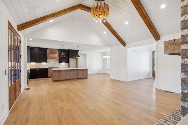 998 Iron Hill Rd, Burns, TN 37029 - kitchen featuring open floor plan, premium range hood, high end range, and a notable chandelier