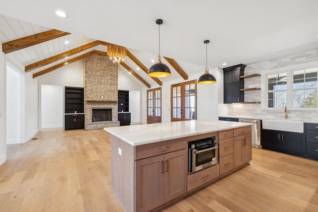 998 Iron Hill Rd, Burns, TN 37029 - kitchen with vaulted ceiling with beams, stainless steel appliances, light wood-type flooring, open shelves, and a sink