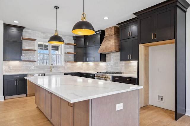 998 Iron Hill Rd, Burns, TN 37029 - kitchen featuring light wood finished floors, appliances with stainless steel finishes, a center island, open shelves, and a sink
