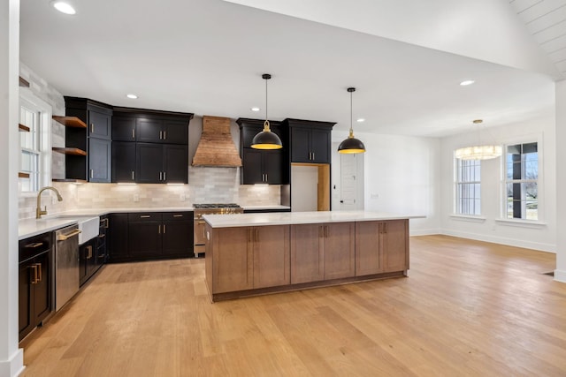 998 Iron Hill Rd, Burns, TN 37029 - kitchen featuring stainless steel appliances, light countertops, a sink, a kitchen island, and premium range hood
