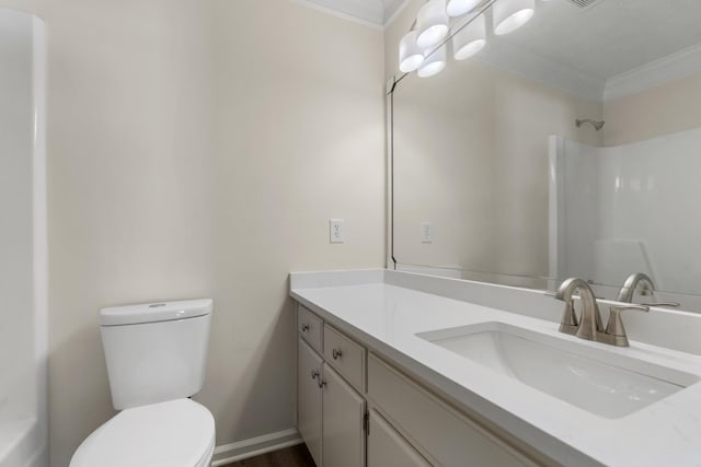 full bath with baseboards, a shower, toilet, crown molding, and vanity