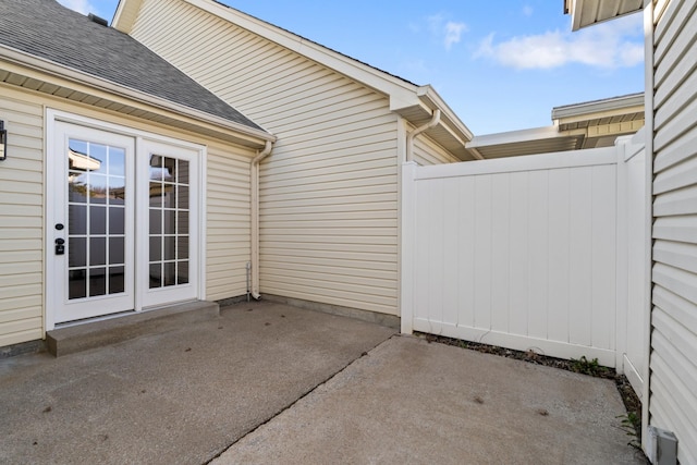 view of patio / terrace featuring fence and french doors